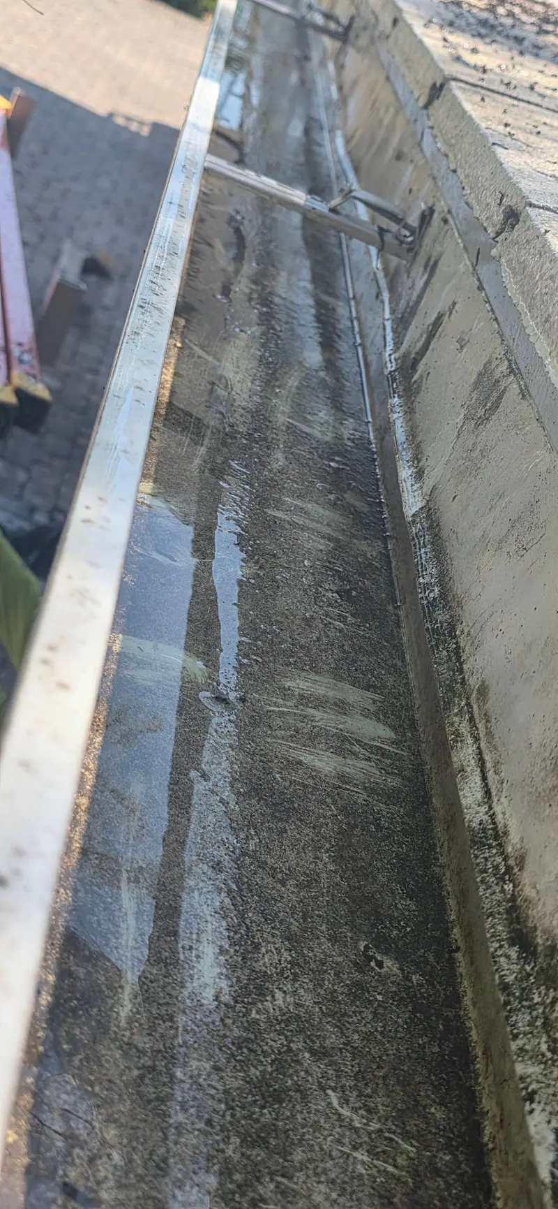 A gutter rinsed out and clear after cleaning