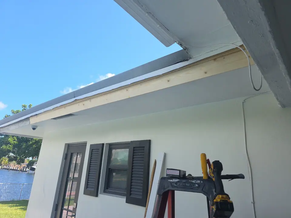 A white eave being prepared, with a ladder and tools on site