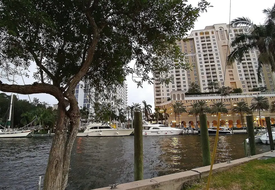 Boats along the New River Riverwalk at dusk in Fort Lauderdale, FL