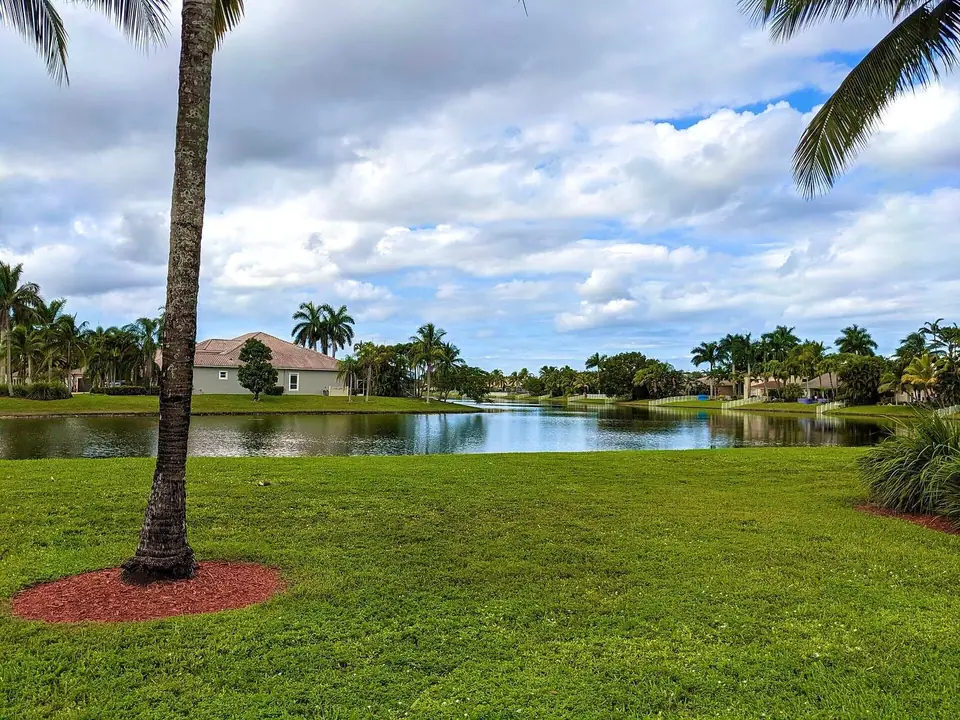 Tile-roof homes across a lake in Pembroke Falls, Pembroke Pines, FL